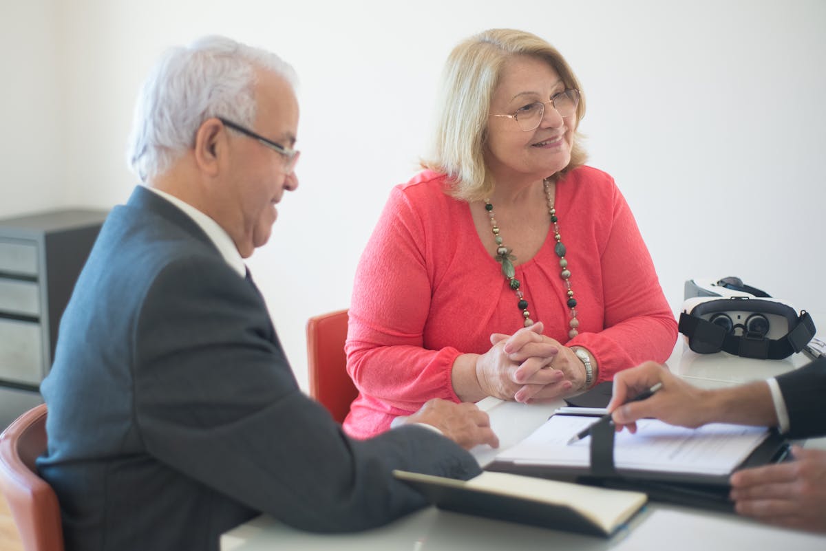 A senior couple meeting with a mortgage advisor.